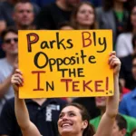 Fan holding a funny sign at a sports game