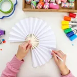 Decorating plain paper fans for a personalized touch