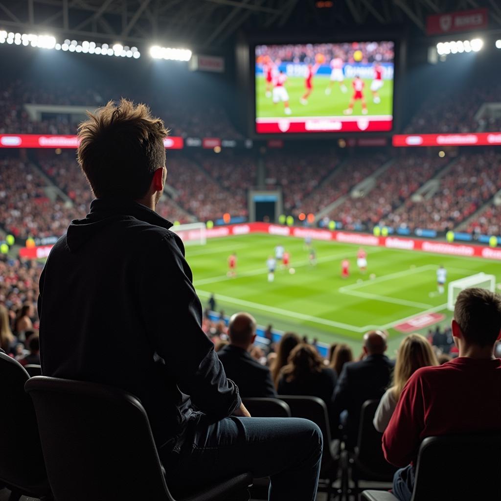 A fan passionately cheering while watching a football match