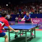 Fan Zhendong and Tomokazu Harimoto clashing during a table tennis match