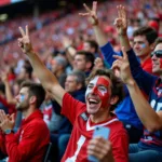 Football fans making hand gestures during a match