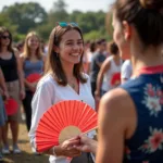 A young woman excitedly receives her Hoshimin fan