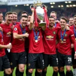 Manchester United players celebrating their 19th Premier League title in 2011