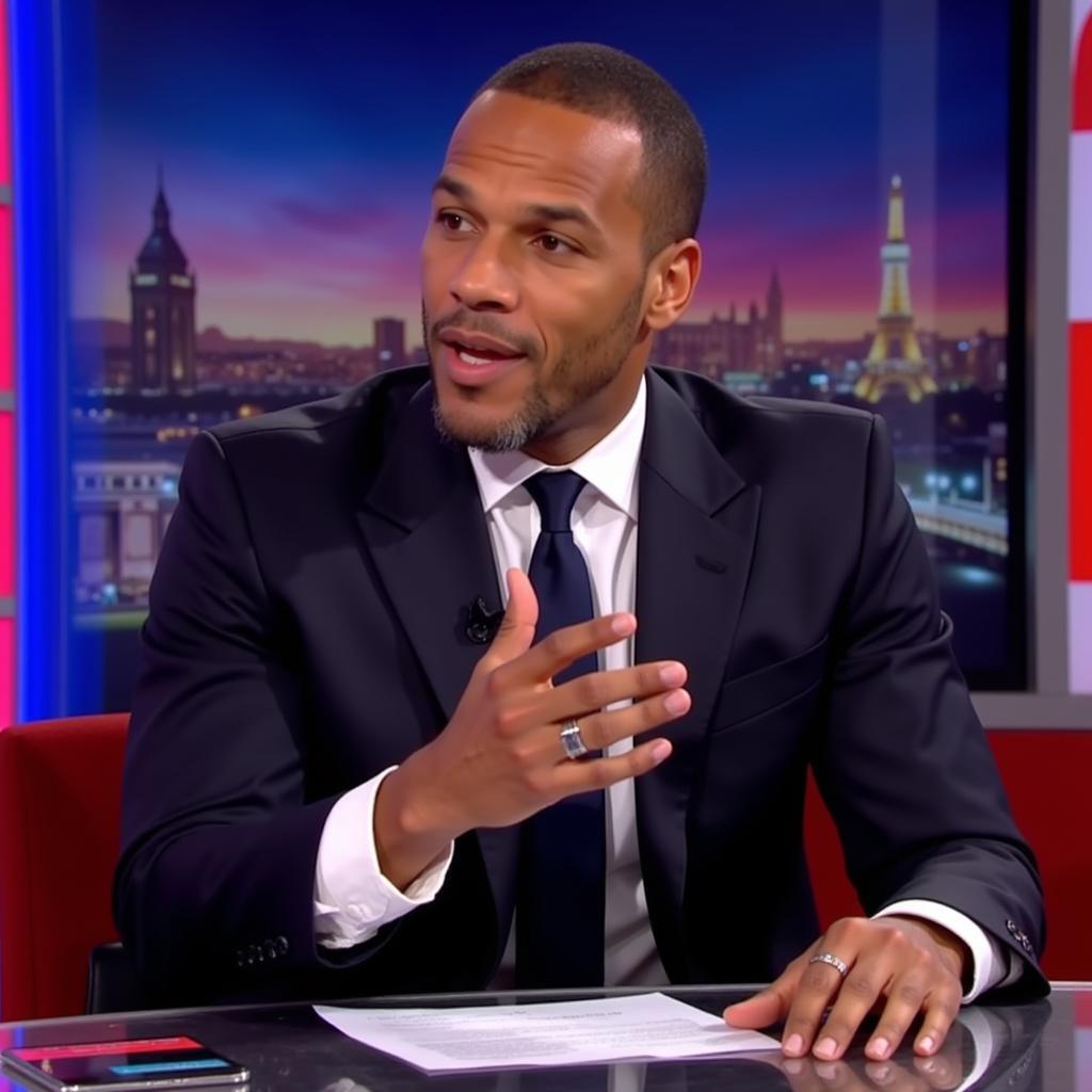 Rio Ferdinand sharing his expert analysis as a pundit.