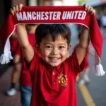 Young Vietnamese fan proudly holding a Manchester United scarf