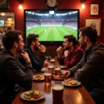 Football fans watching a match at a pub