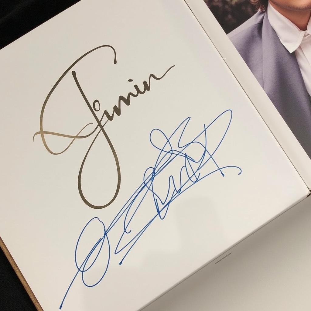 Close-up of a Jimin signed album