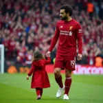 Mohamed Salah and Makka on the Anfield pitch after a Liverpool match.