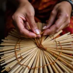 Indian artisan crafting a bamboo fan