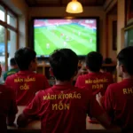 Vietnamese football fan engrossed in a match