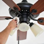 Cleaning a Honyar ceiling fan to maintain optimal performance.